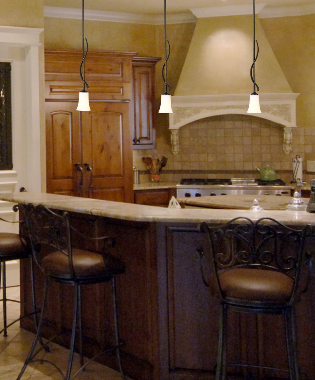 Art glass pendant lights add warmth to a kitchen island.