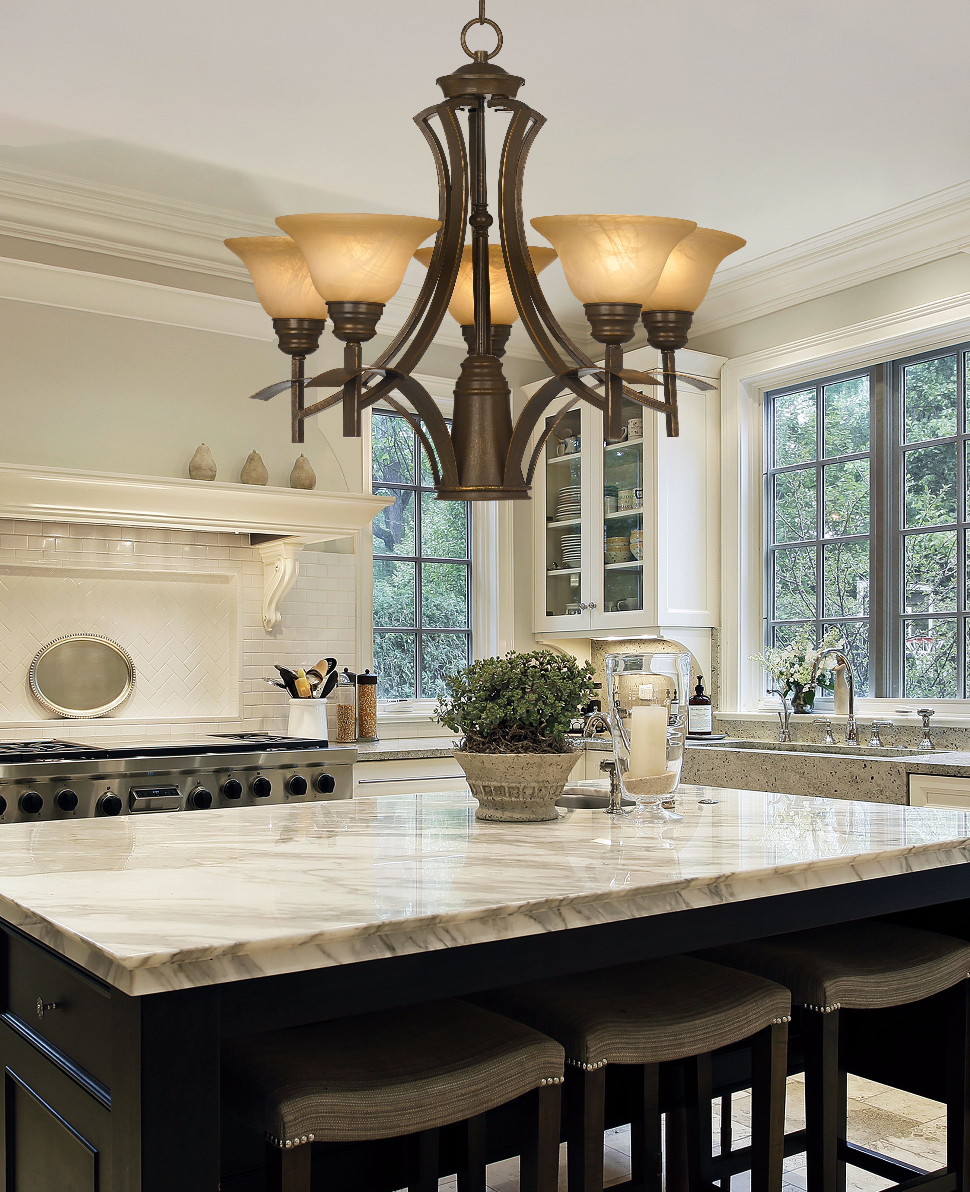 Mini pendant chandeliers cast an inviting glow in this traditional kitchen.