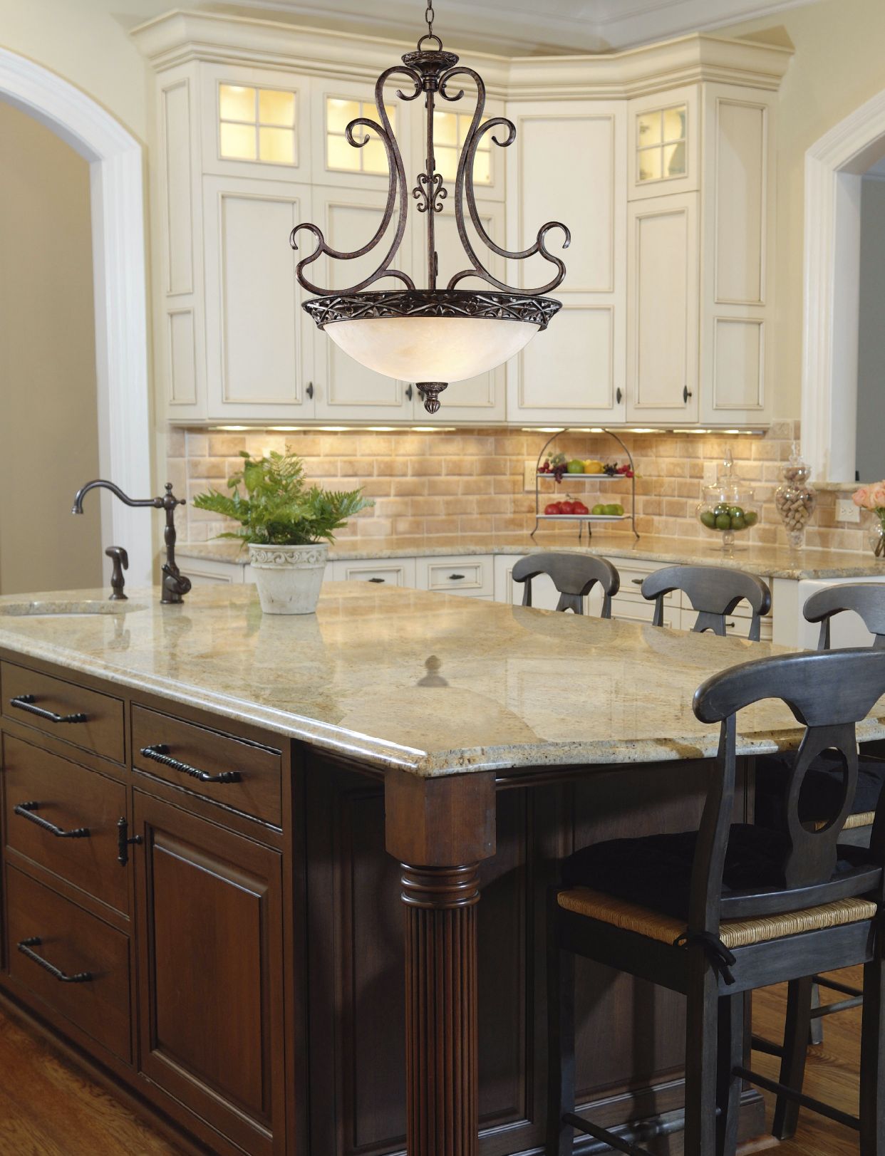 A French-style chandelier complements traditional kitchen decor.