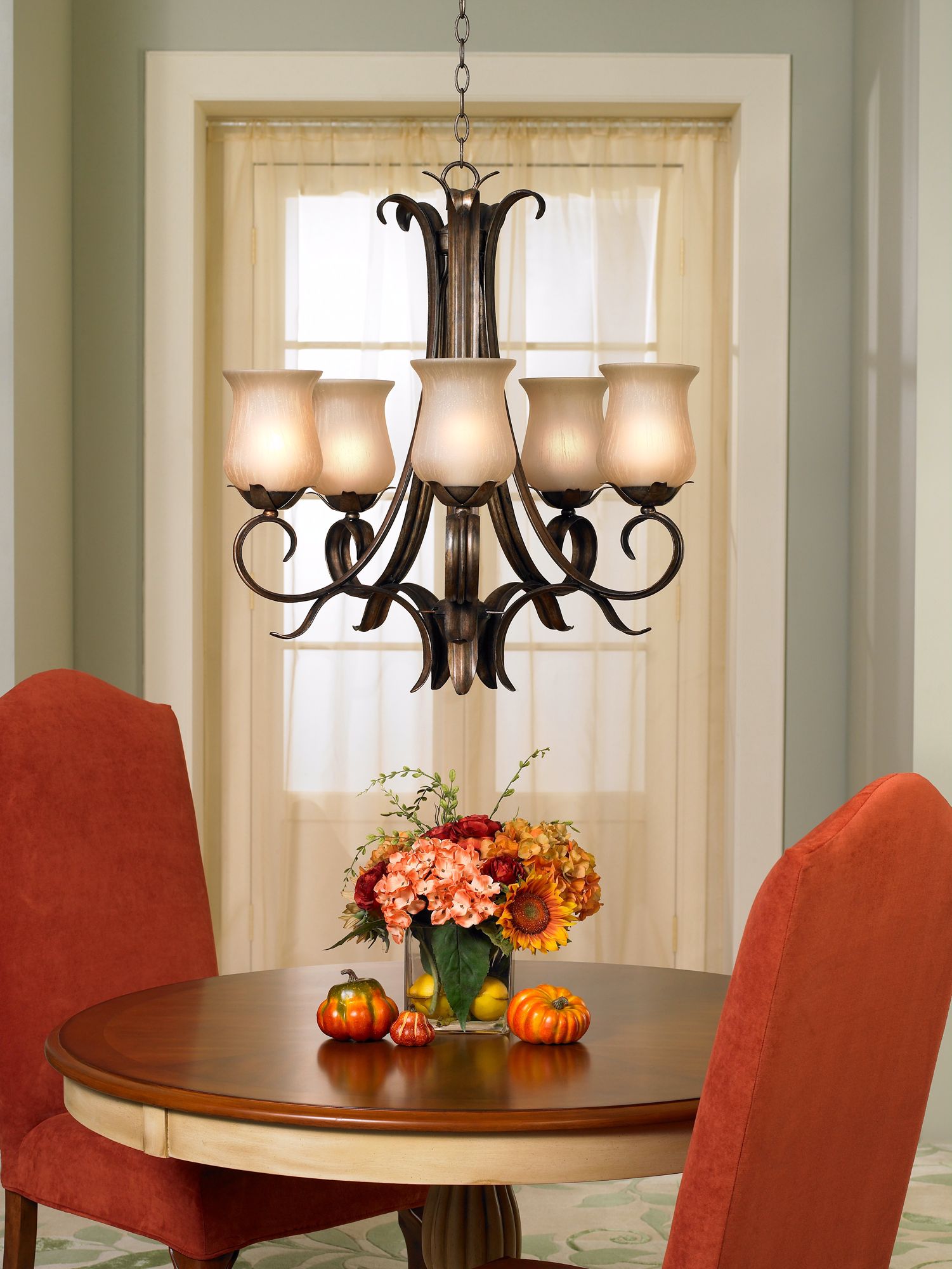 A traditional chandelier is the centerpiece in this dining room decorating.