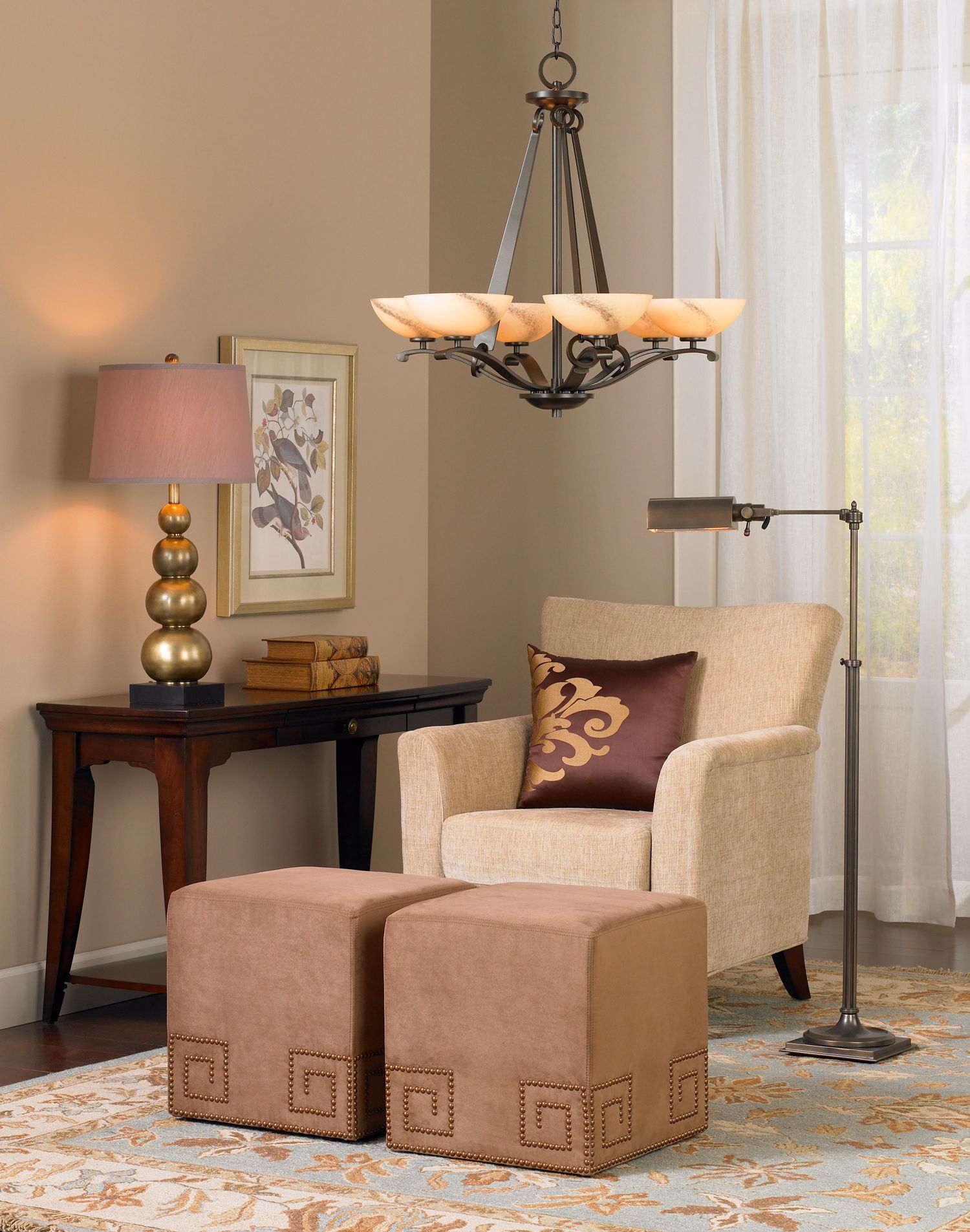 The living room design incorporates touches of soft reds and brass.