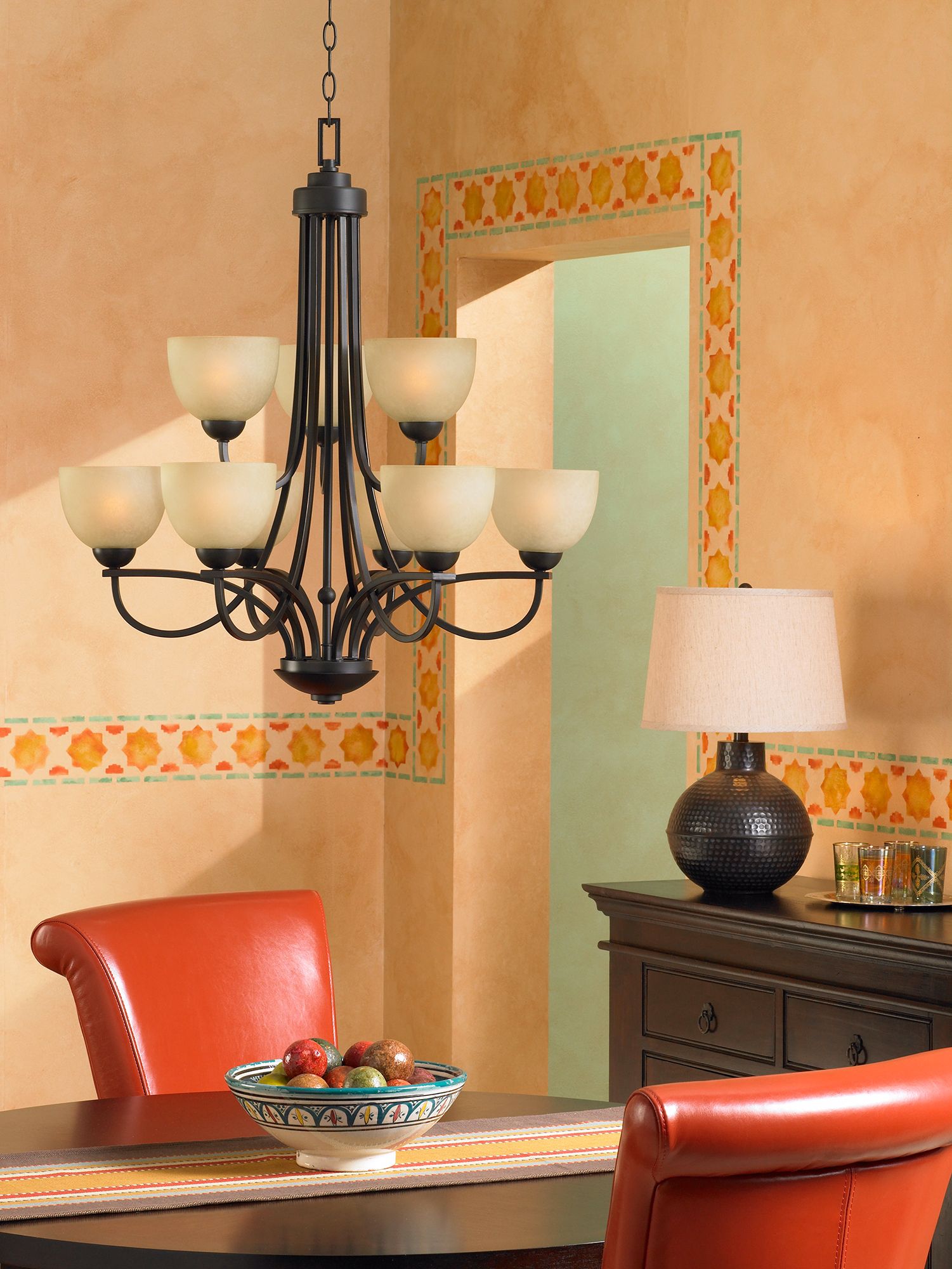 Add a table lamp near a chandelier for a beautiful dining room lighting idea.