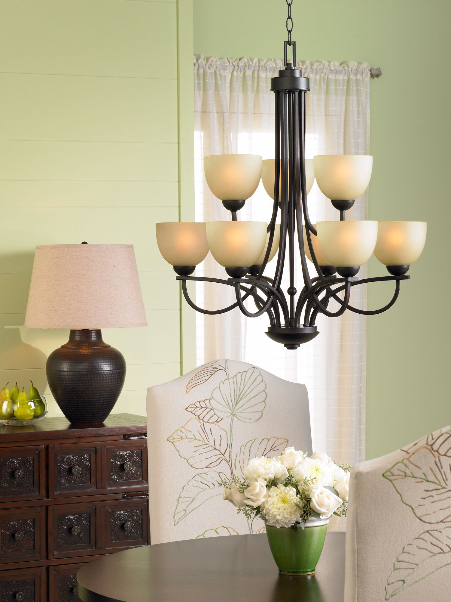 Put a table lamp near a chandelier for a luxe dining room lighting idea.