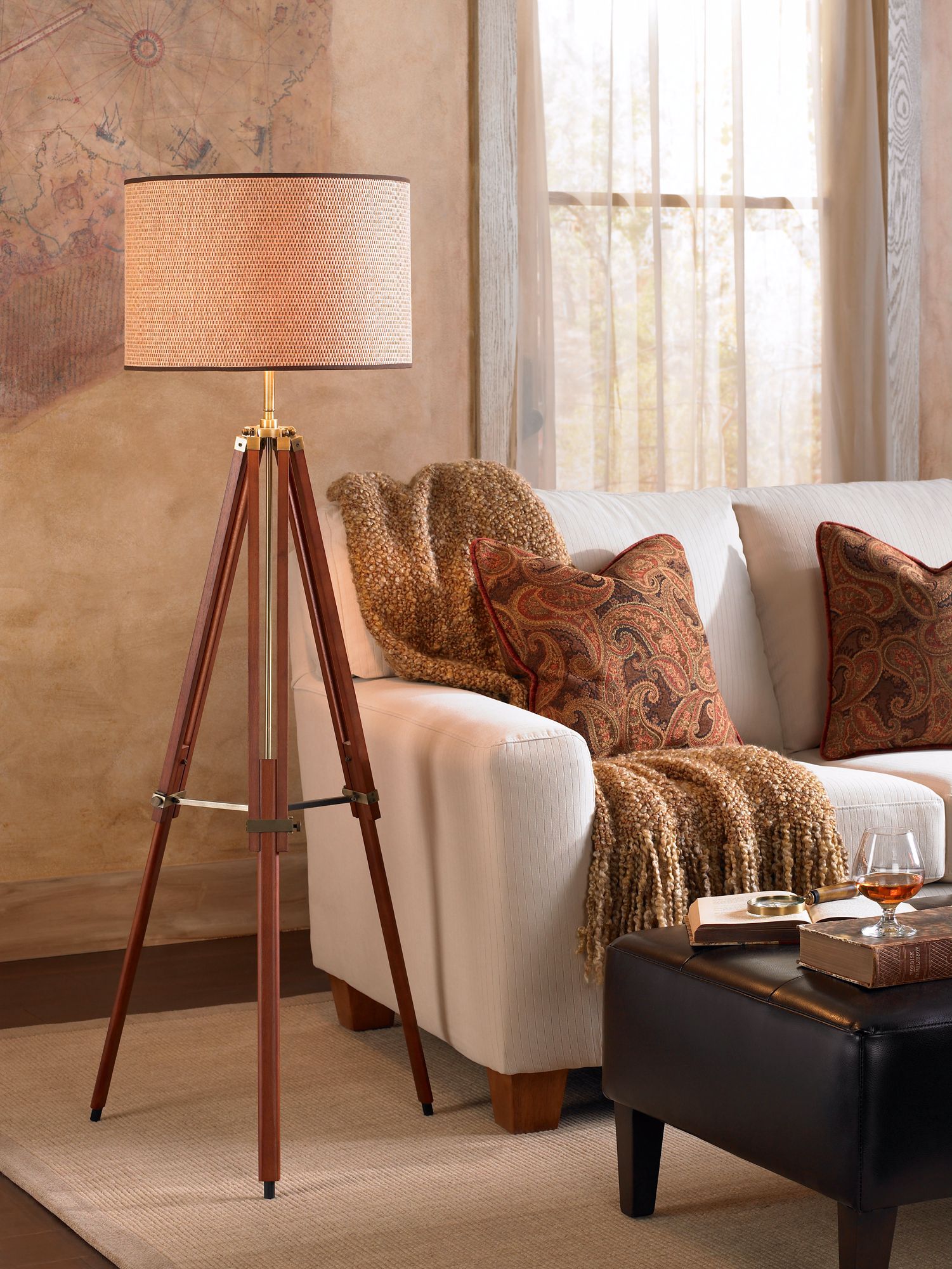 A tripod lamp makes a handsome design statement in a traditional living room.
