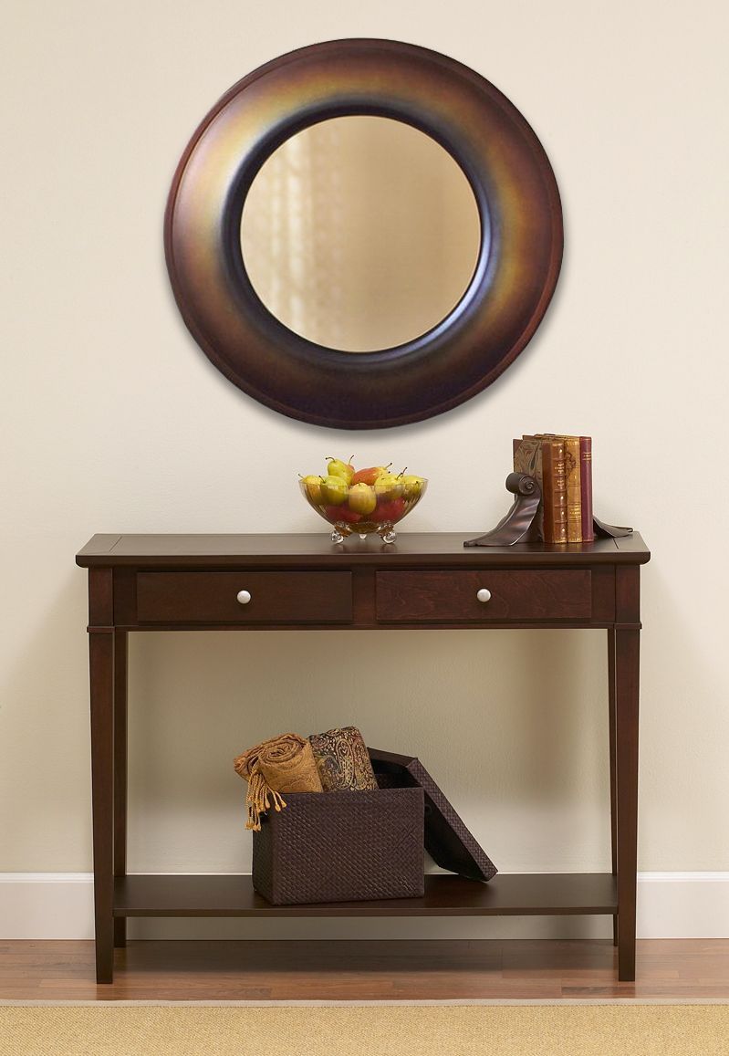 A wall mirror in the hallway opens up the space and adds functionality.