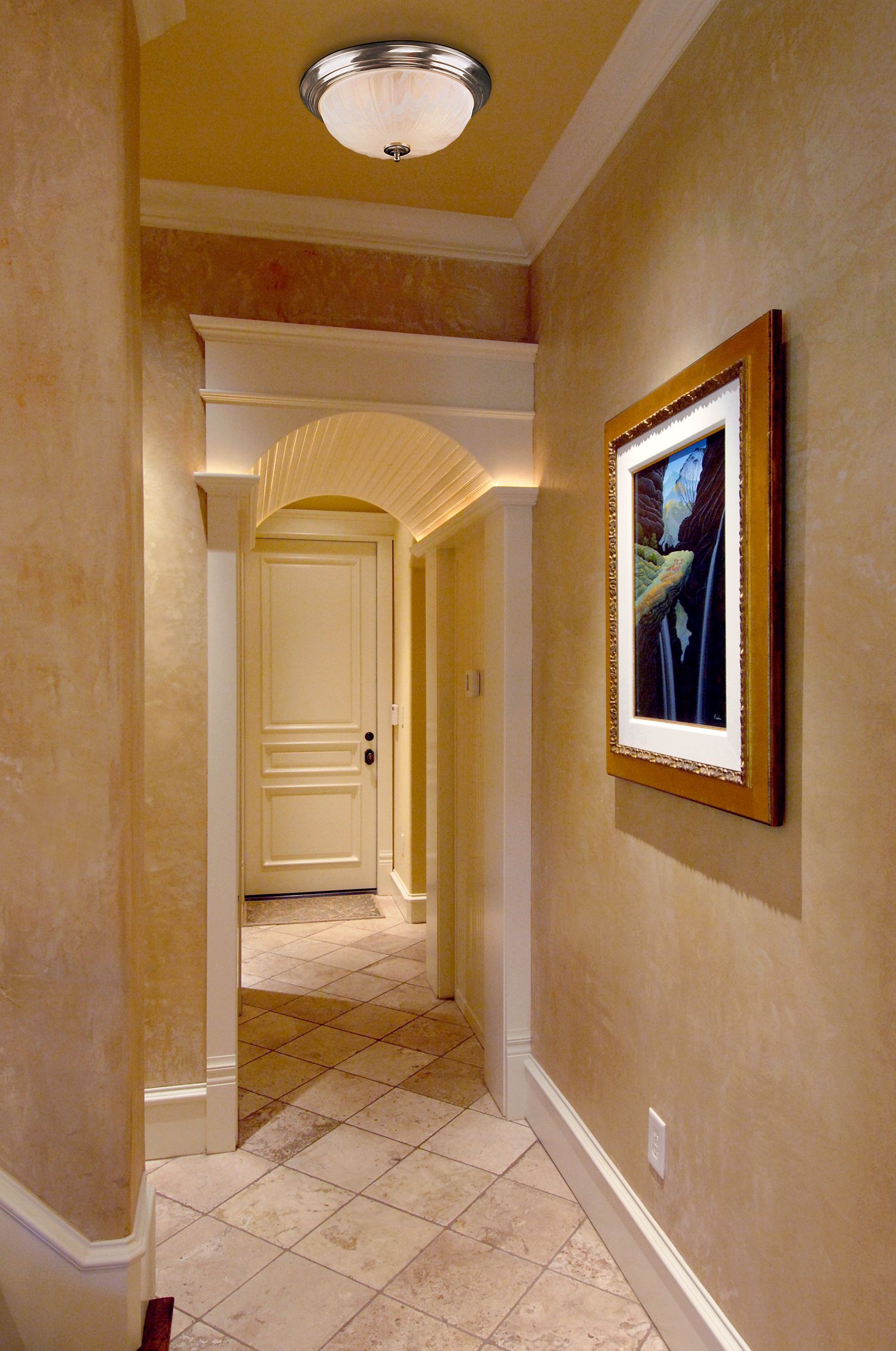 A subdued frosted glass ceiling fixture adds unobtrusive lighting to a hallway.