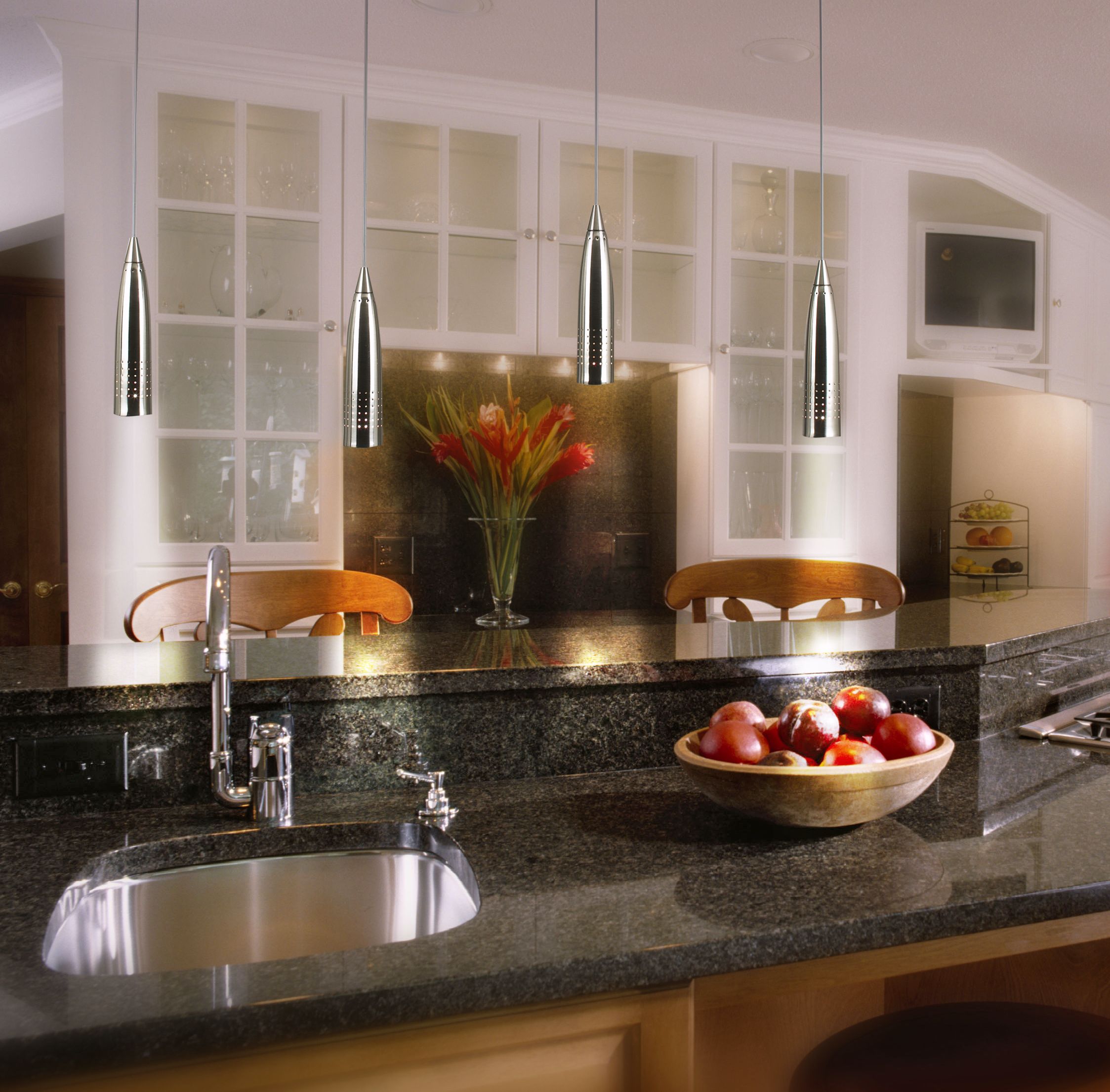 Polished granite & brushed steel are a chic combo in this contemporary kitchen.