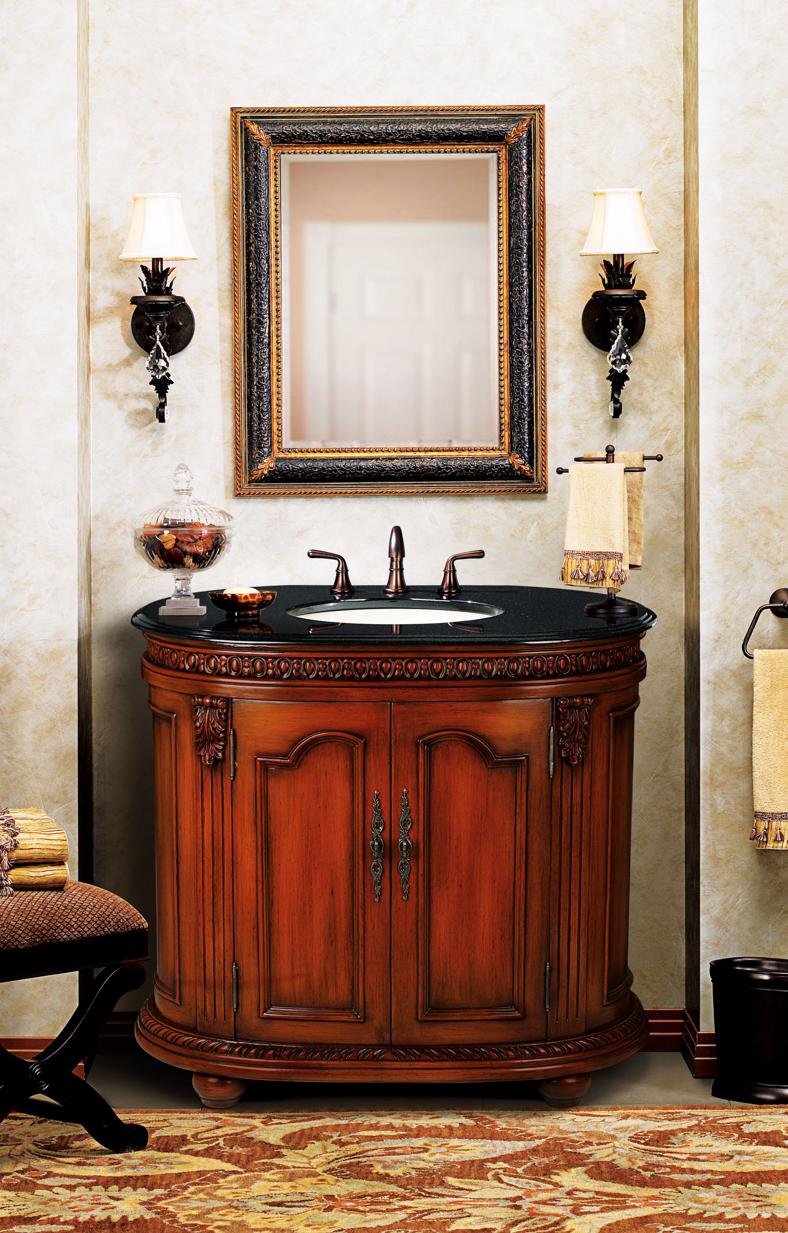 A dark granite counter top makes a statement in a traditional bathroom.