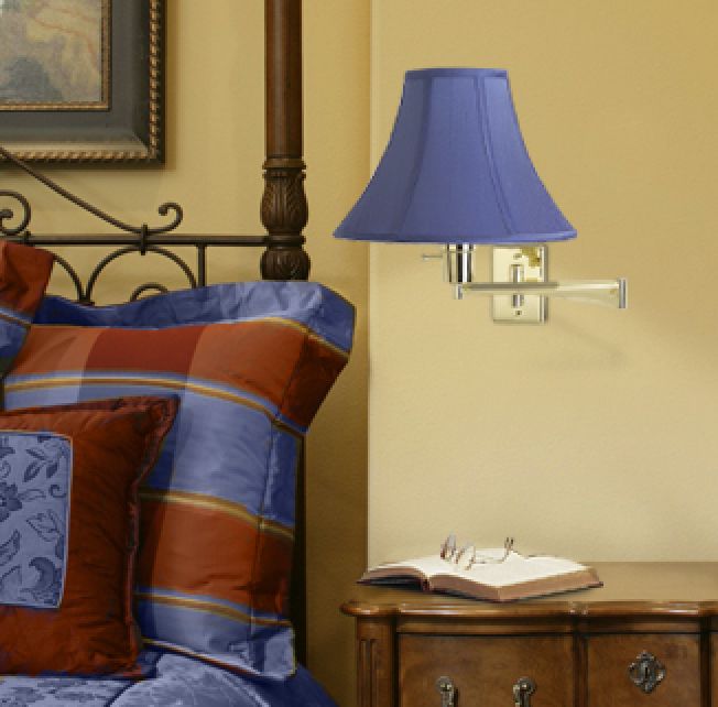Red and blue plaids and a blue swing arm light define the traditional bedroom.