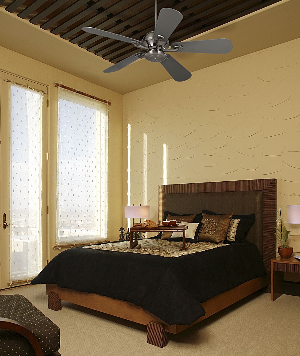 The Casa Fusion ceiling fan draws attention to the bedroom's high ceiling.