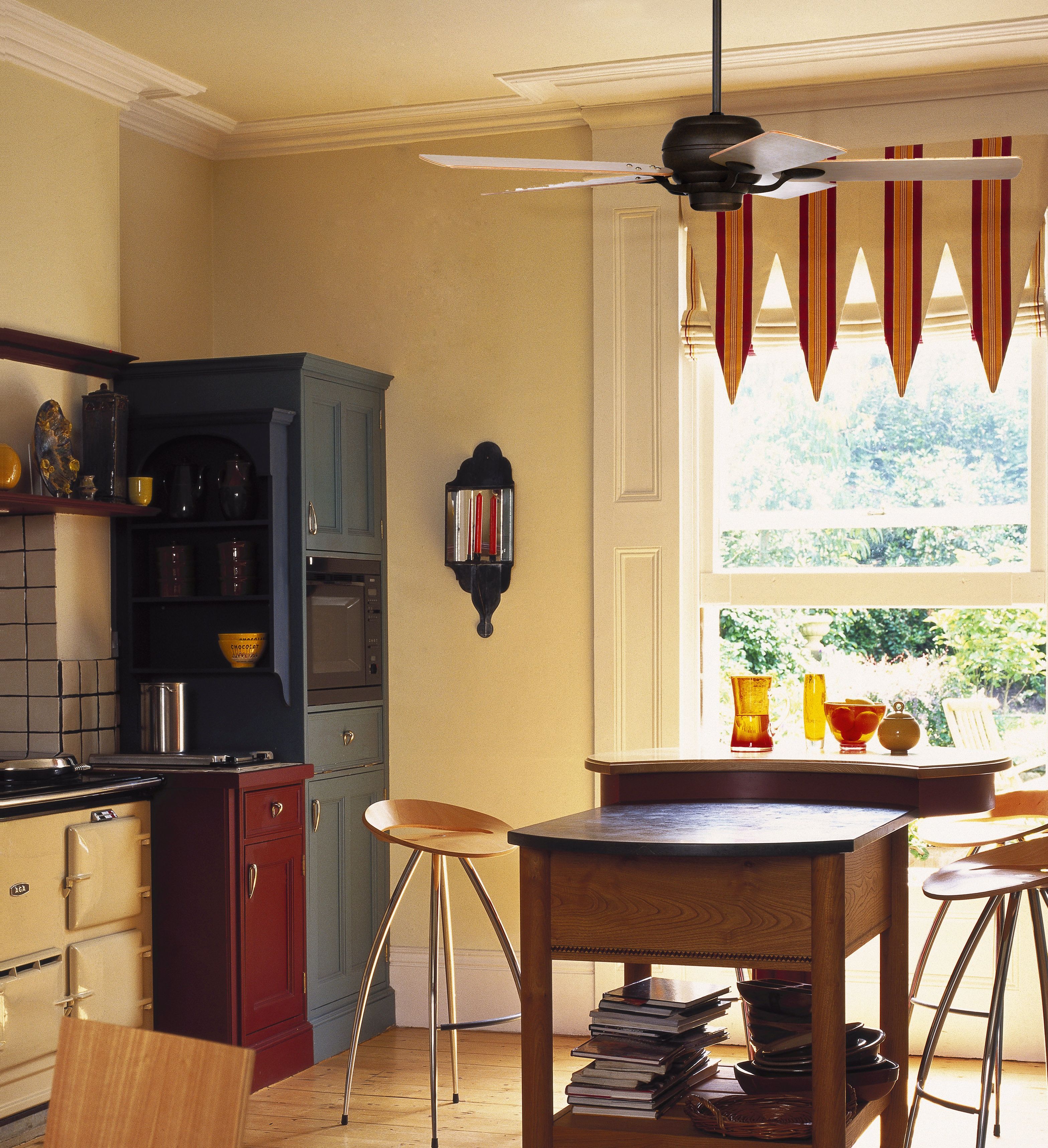 A ceiling fan with maple veneer blades adds warmth to this kitchen decor.