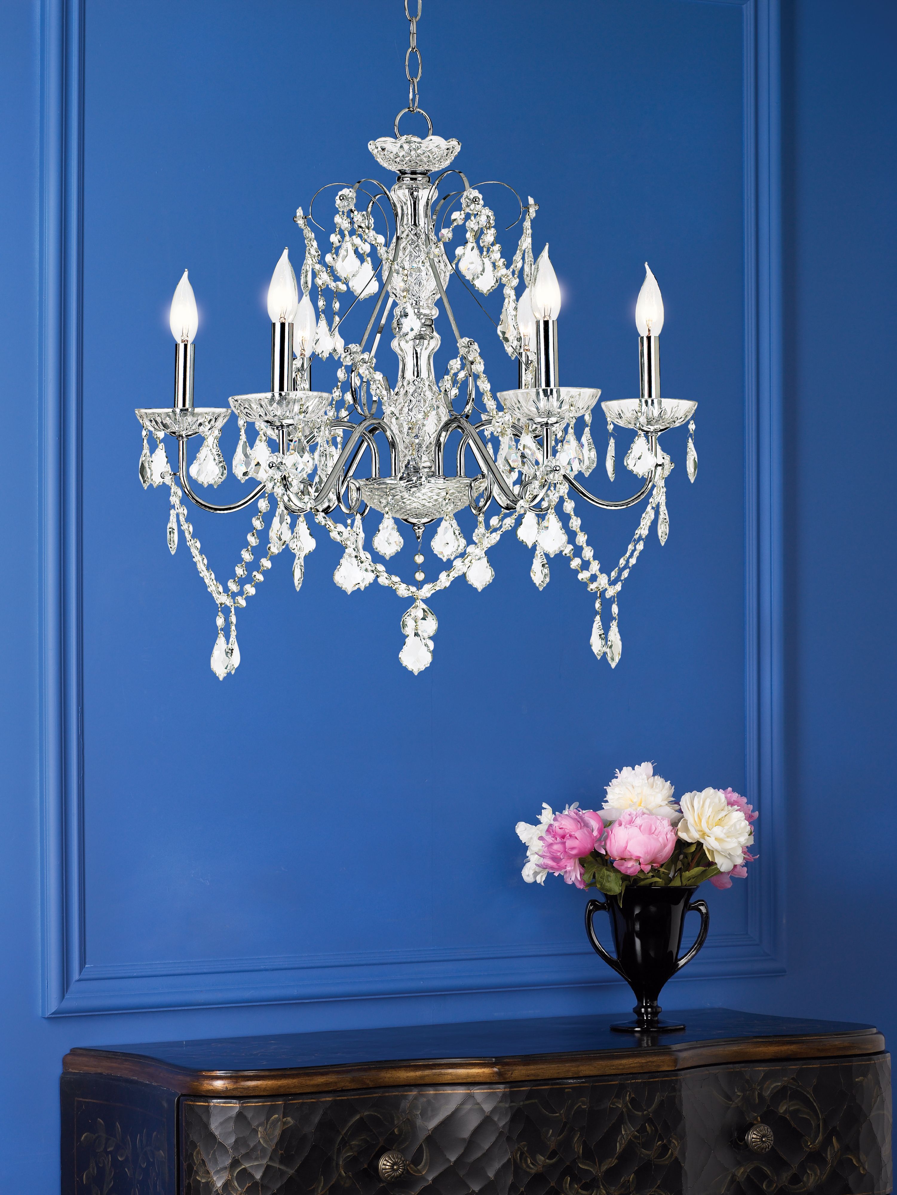 The crystal chandelier is a bold element when juxtaposed with the blue wall.