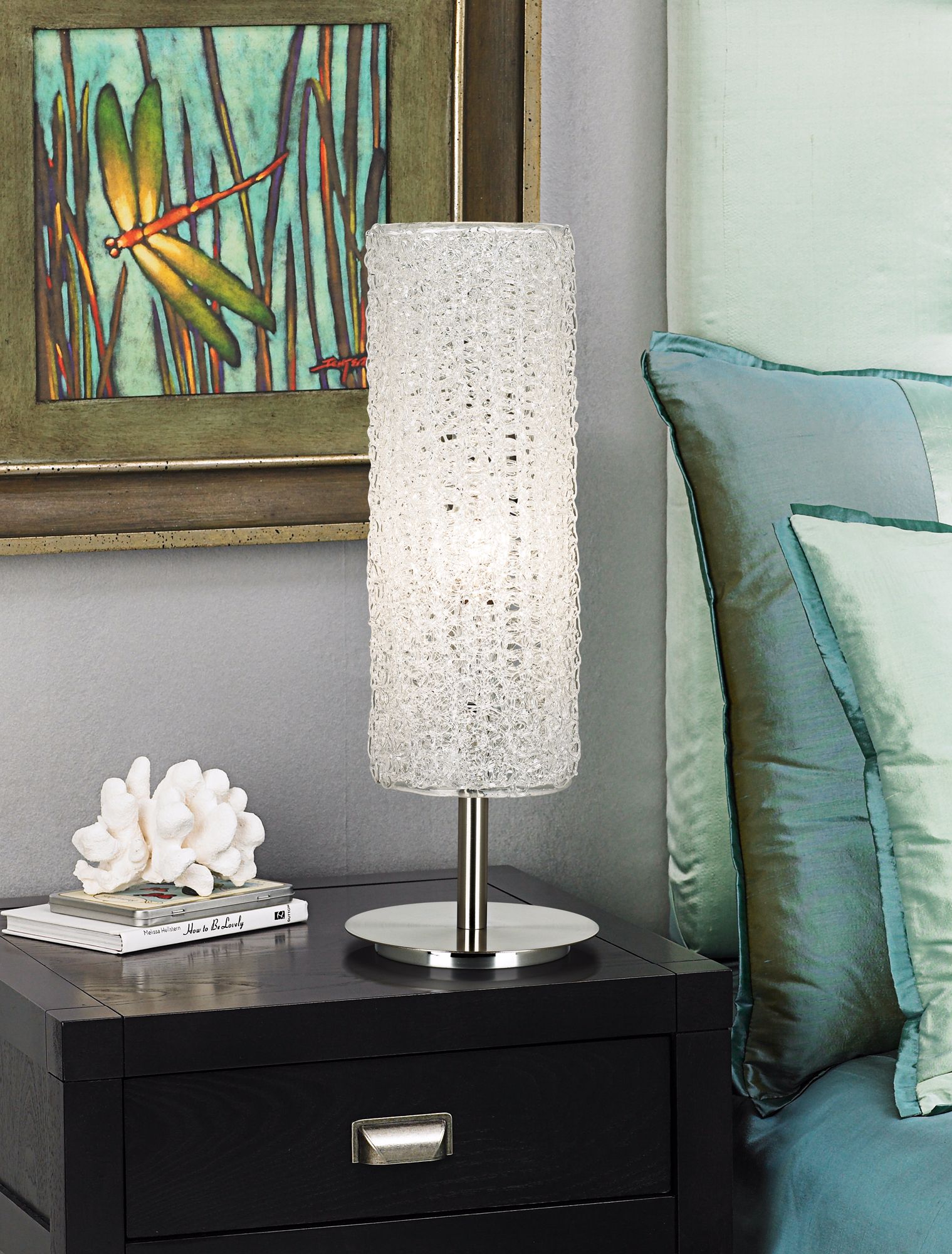 Layered aqua tones creates a lush and inviting look in a contemporary bedroom.