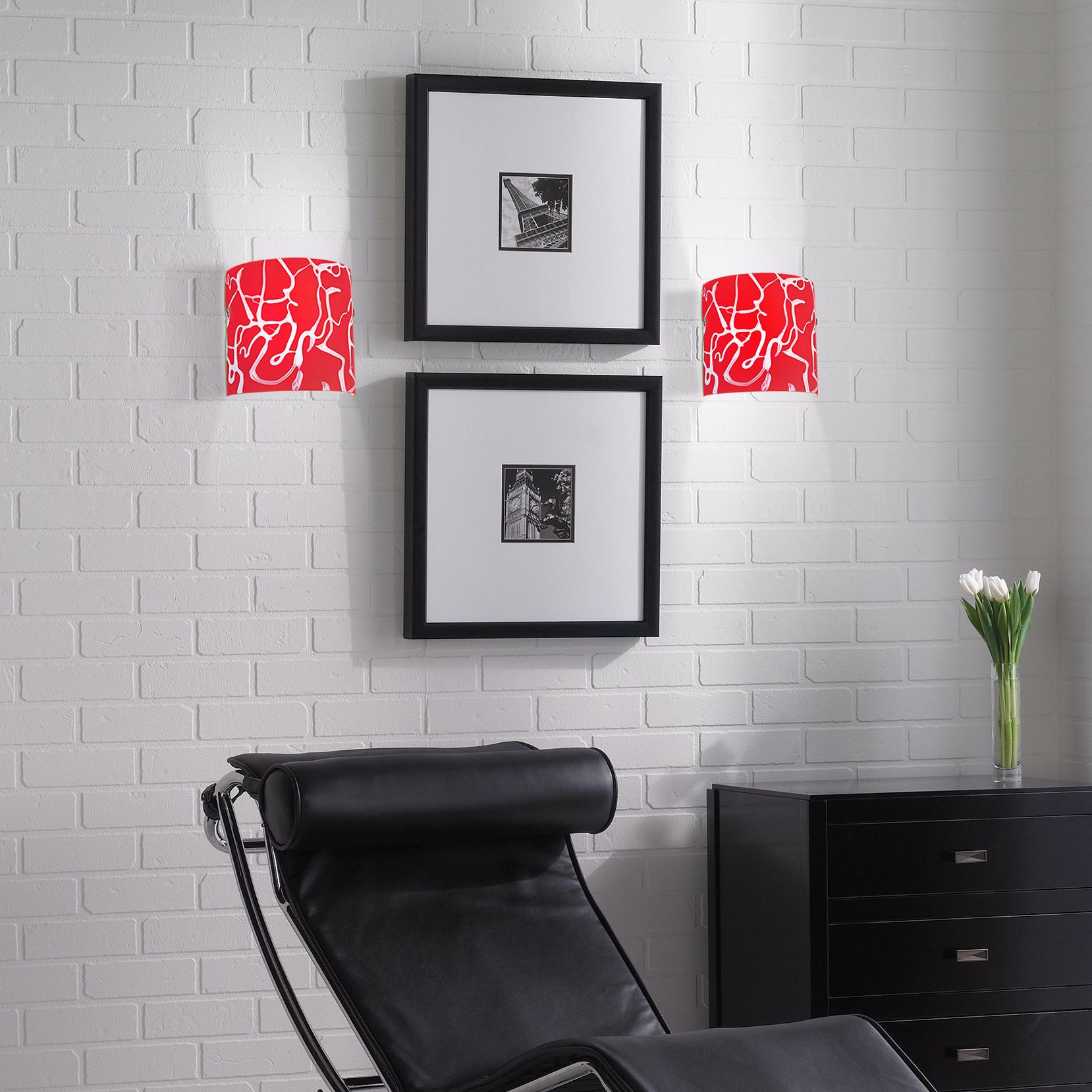 Artful red wall sconces add a major punch to this black and white living room!