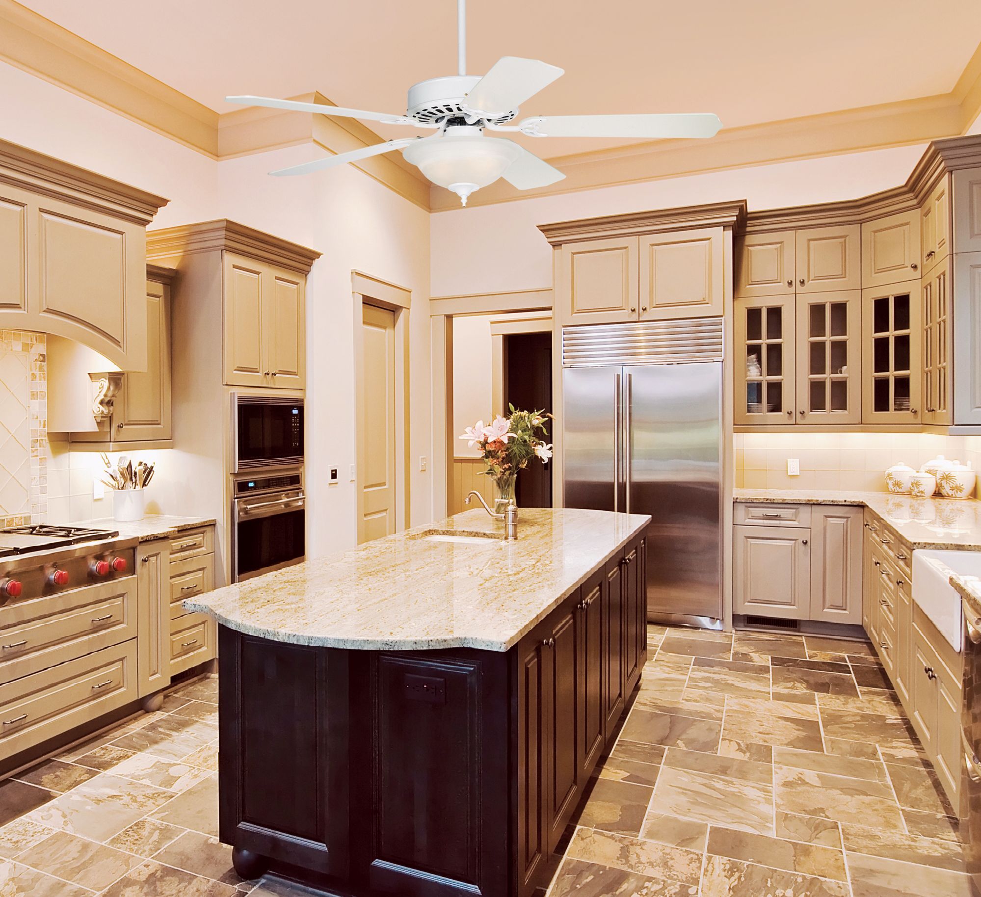 A crisp white ceiling fan is a practical addition to a traditional kitchen.