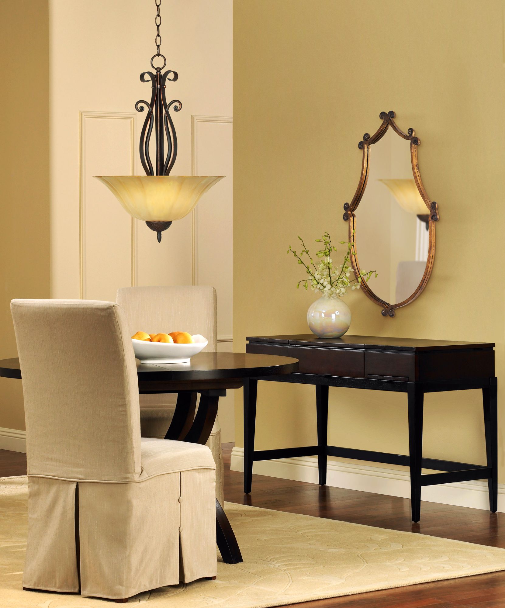 A slipcovered chair softens up a transitional dining room design.