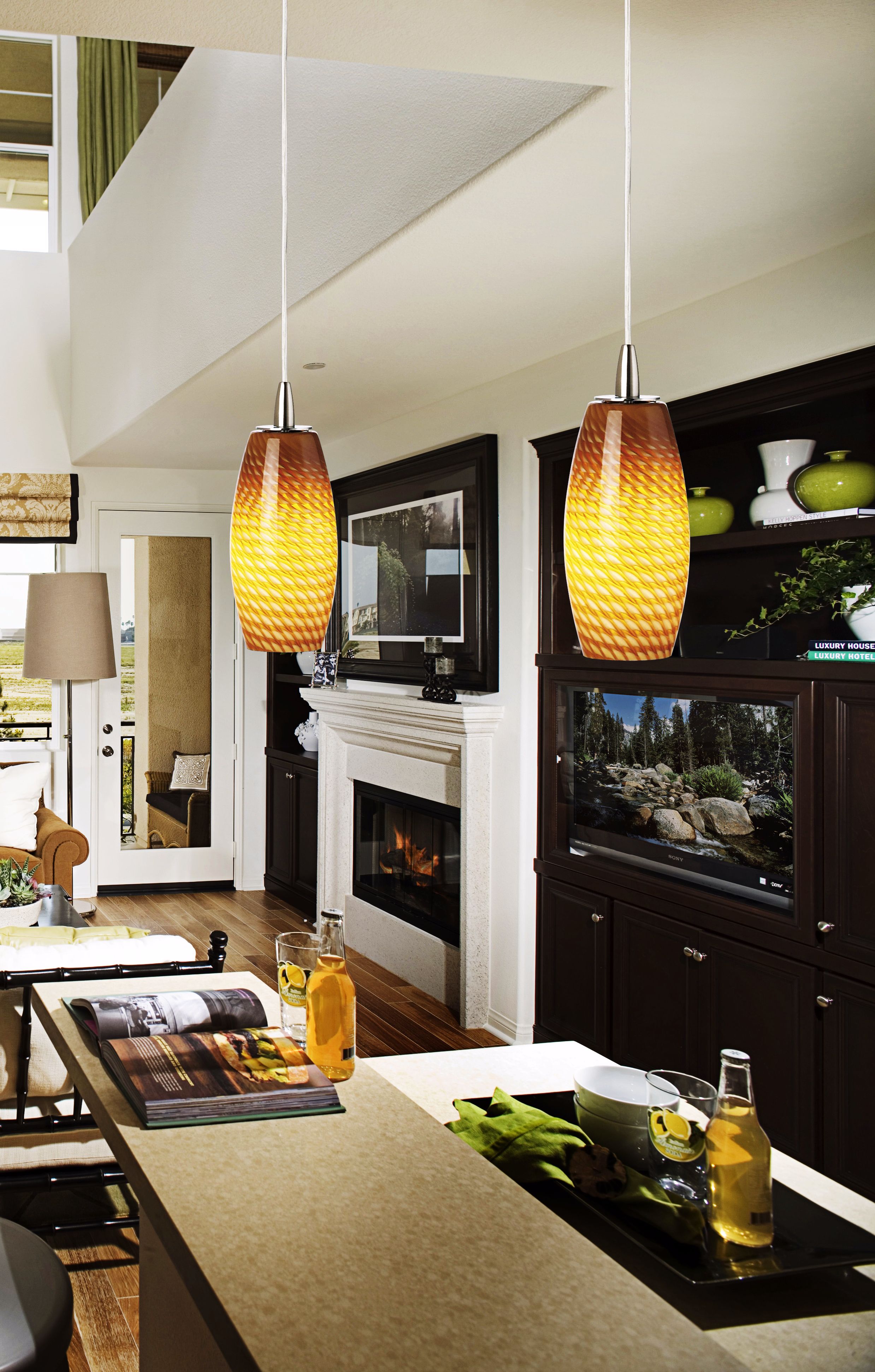 Colorful contemporary pendant lights add interest to a black and white room.