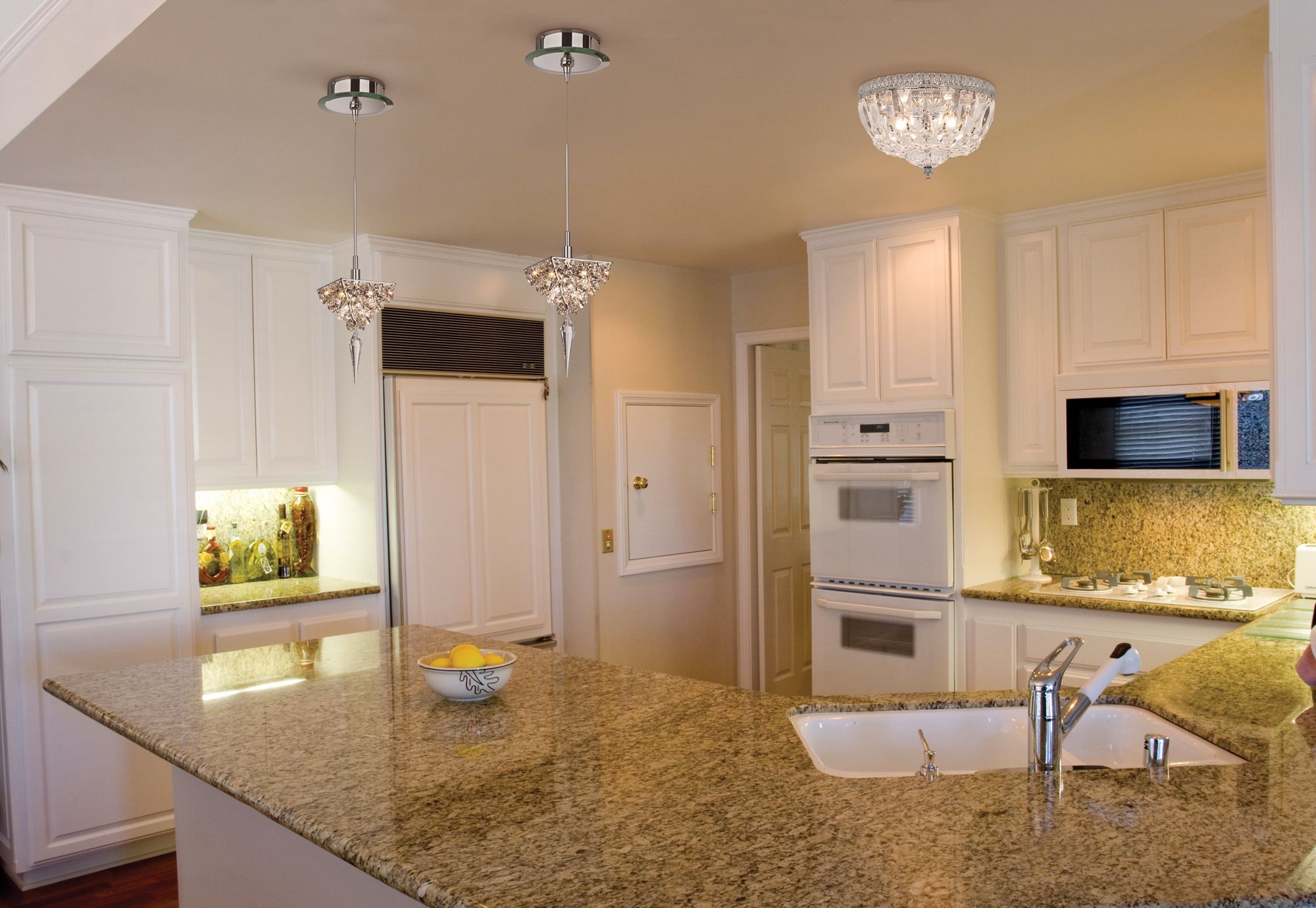 Crystal lighting adds unexpected sparkle to a traditional kitchen design.