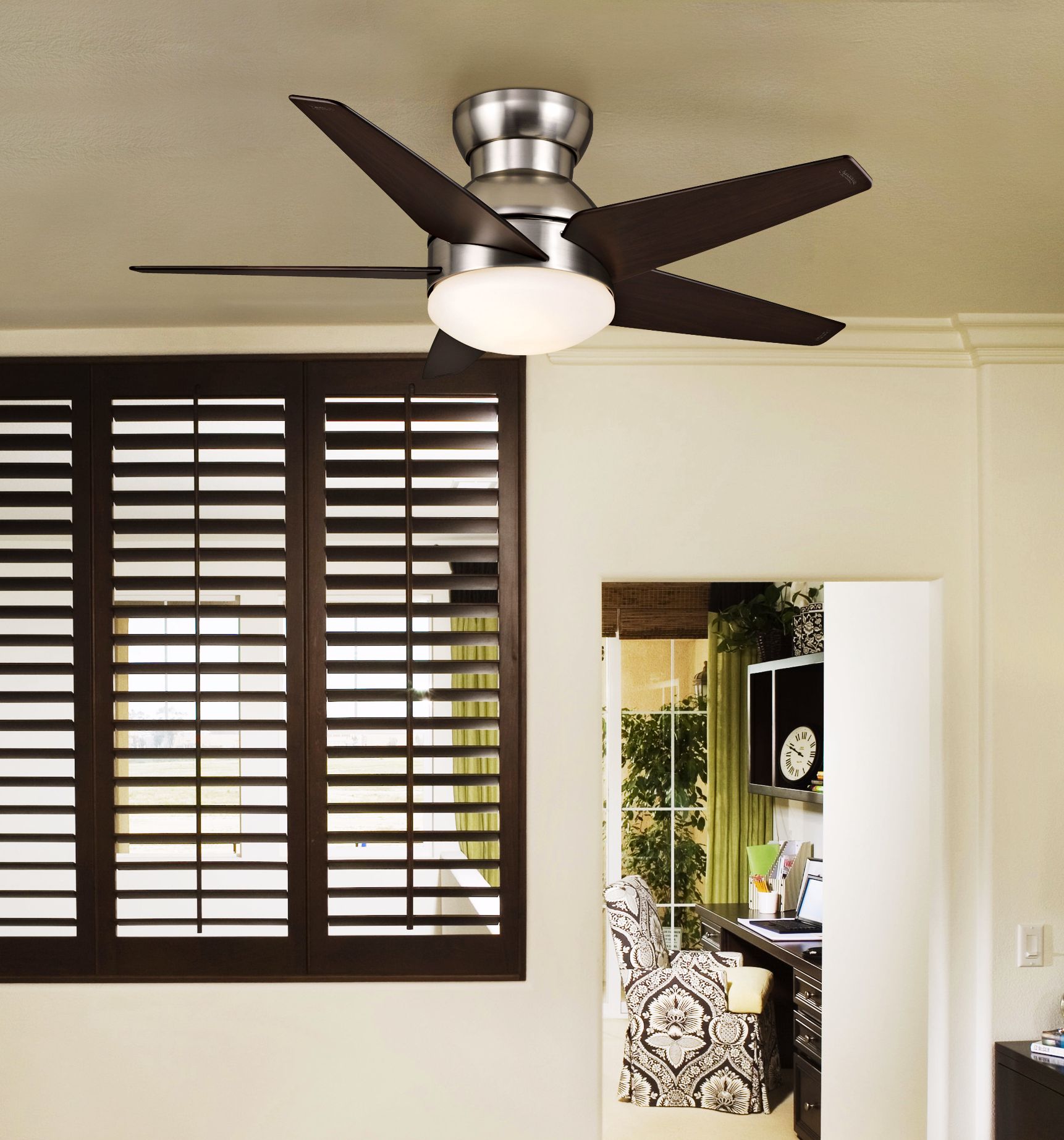 A contemporary ceiling fan accents a minimal master bedroom design.