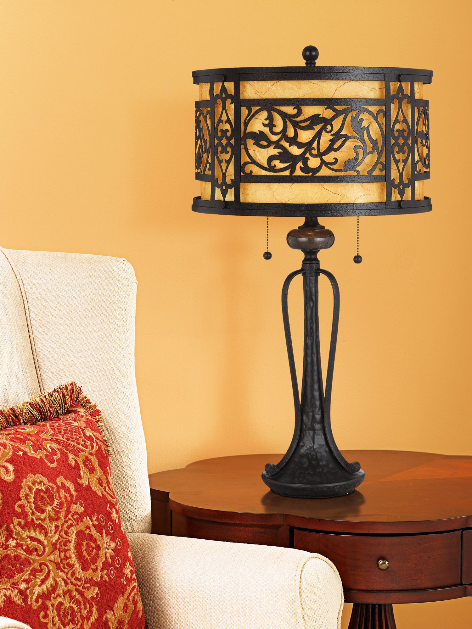 An ornately designed table lamp is the focus in this traditional living room.