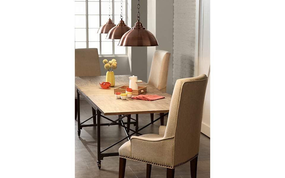 Style trend of large pendants over a dining room table.