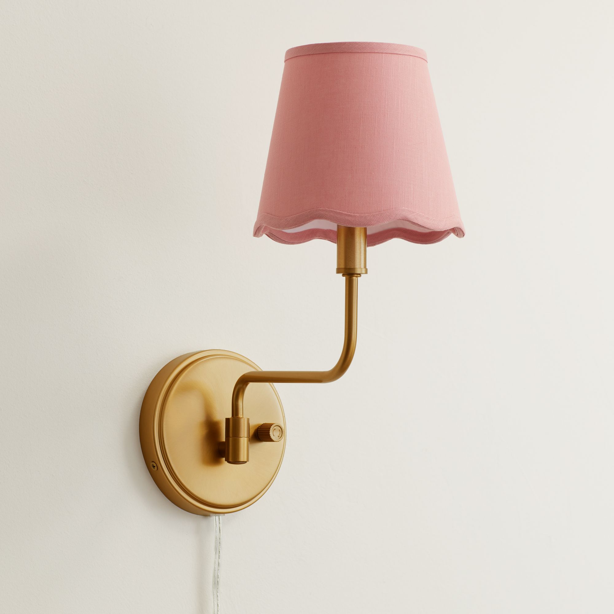 Image 1 Ophelia 9 1/2"H Warm Brass Plug-In Wall Sconce with Pink Scallop Shade in scene