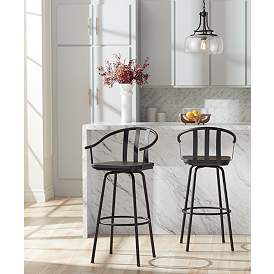 Image1 of Lael 25 1/4" High Black Metal and Wood Swivel Counter Stool in scene