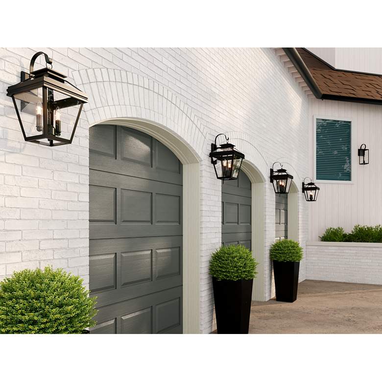 Image 1 John Timberland Mira 21" High Black Finish Outdoor Lantern Wall Light in scene