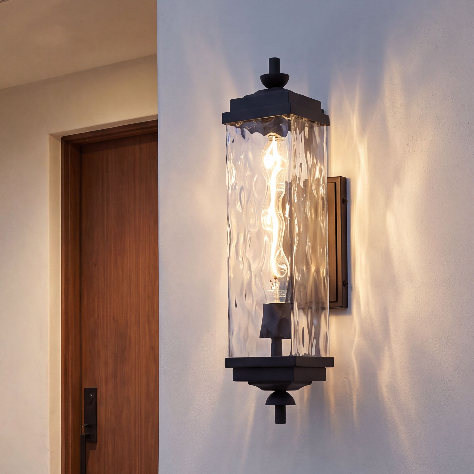 Image 1 John Timberland Valentino 22" Black and Water Glass Outdoor Wall Light in scene