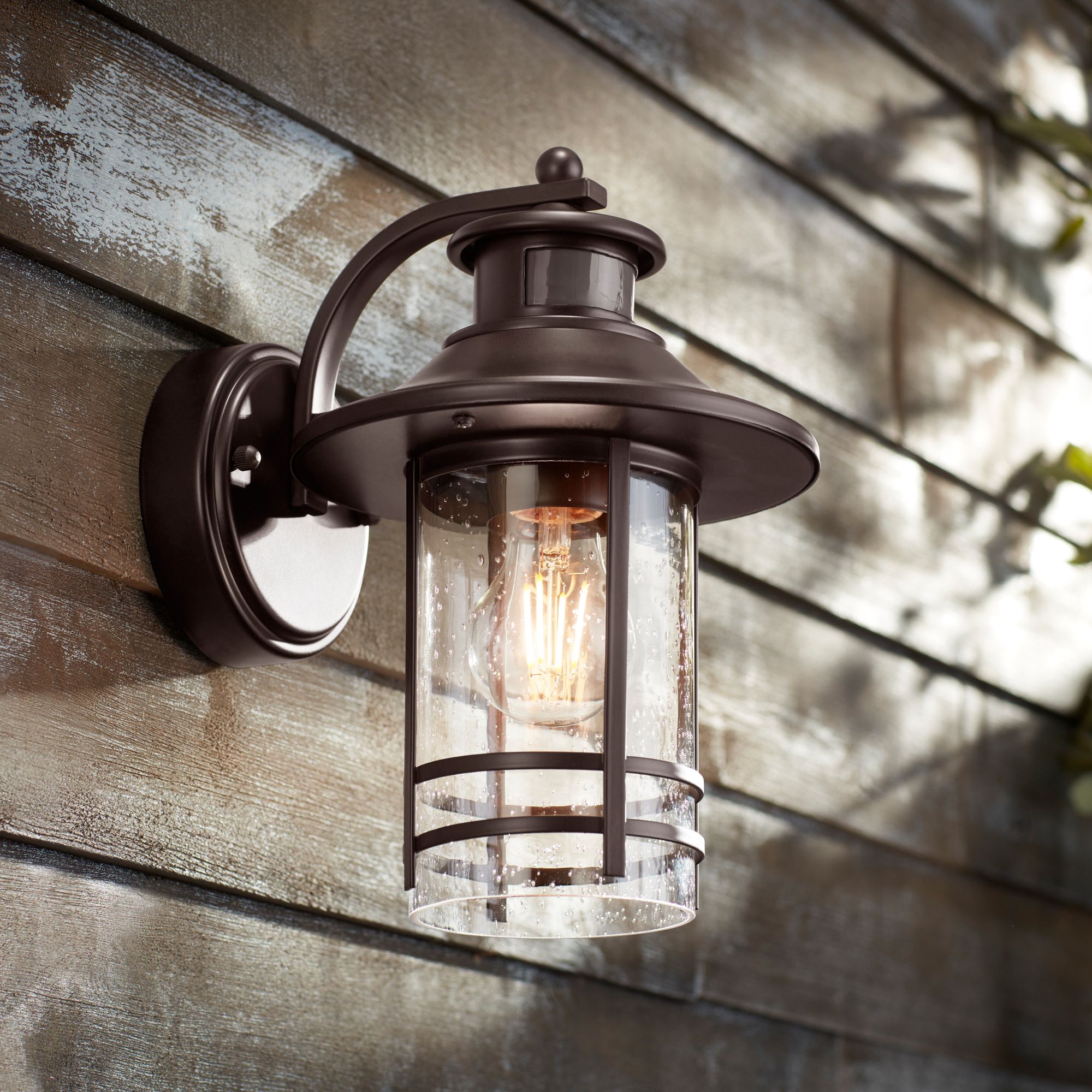 Image 1 John Timberland Galt 11 1/4" Bronze Motion Sensor Outdoor Wall Light in scene