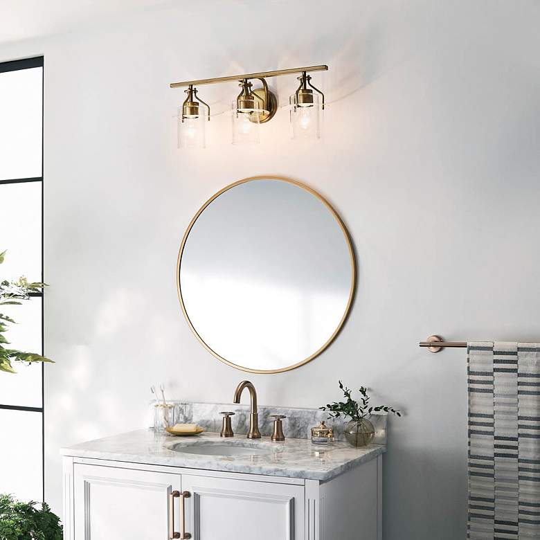 Image 1 Kichler Everett 24" Wide 3-Light Brass and Clear Glass Bath Light in scene