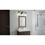 Emerson 24" Wide Matte Black and Gold Bath Light by Quoizel in scene