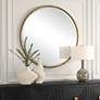 1_Uttermost Sutton Aged Gold 47" Round Oversized Wall Mirror in scene