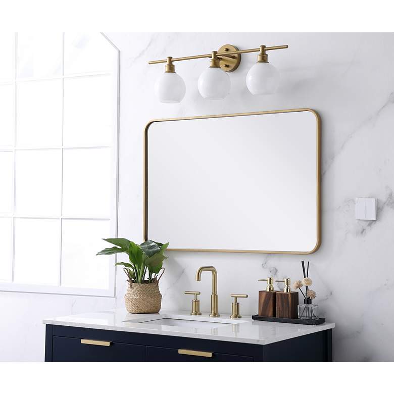Image 1 24-in W x 36-in H Soft Corner Metal Rectangular Wall Mirror in Brass in scene