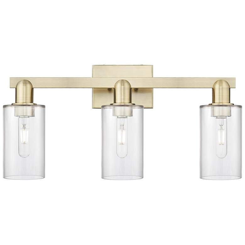 Image 1 Arcadia Clymer 23"W 3 Light Antique Brass Bath Light With Clear Shade