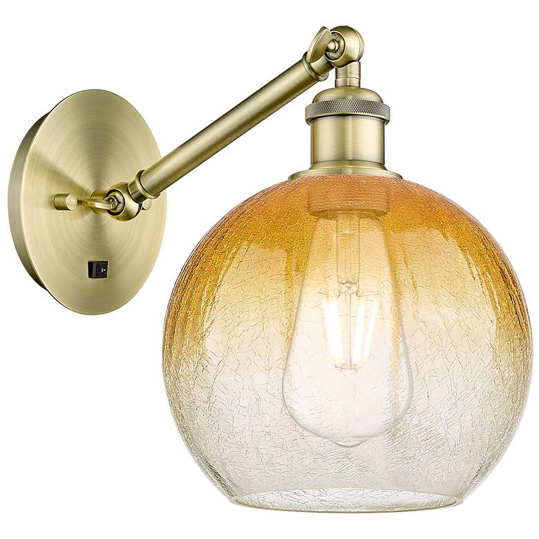 Image 1 Ballston Brookhaven Globe 10"H Brass Swivel Sconce With Amber Shade
