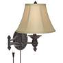 Barnes and Ivy Godia Bronze Oval Plug-In Swing Arm Wall Lamp in scene
