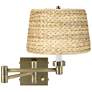 Barnes and Ivy Woven Seagrass Antique Brass Plug-In Swing Arm Wall Lamp in scene