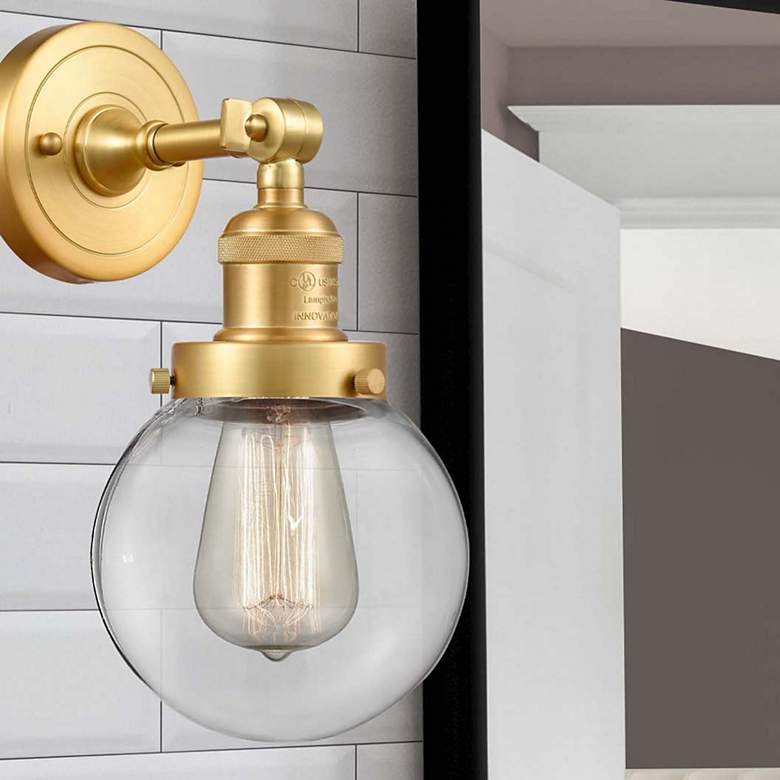 Image 1 Beacon 12" High Satin Gold Wall Sconce with Clear Glass