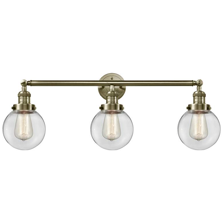 Image 1 Beacon 3 Light 30" Bath Light - Antique Brass - Clear Shade