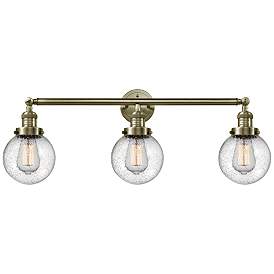 Image1 of Beacon 3 Light 30" Bath Light - Antique Brass - Seedy Shade