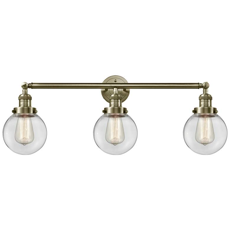 Image 1 Beacon 3 Light 30 inch LED Bath Light - Antique Brass - Clear Shade