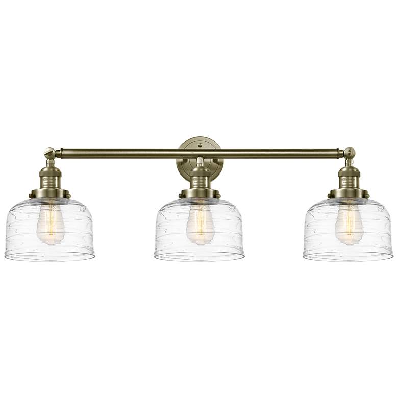 Image 1 Bell 3 Light 32" Bath Light - Antique Brass - Clear Deco Swirl Shade