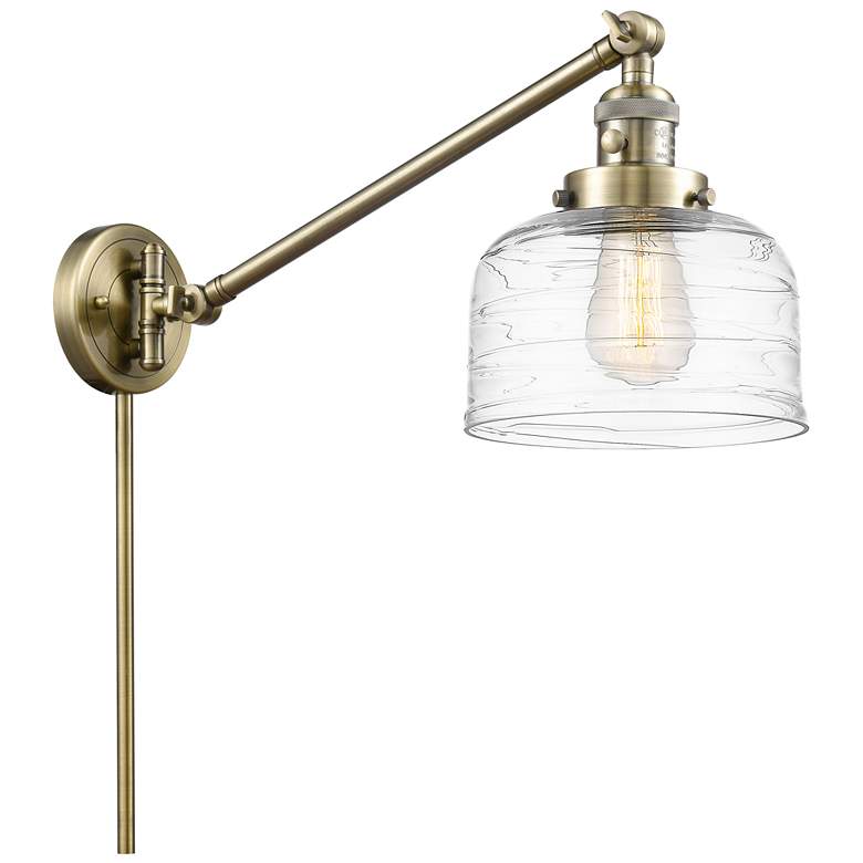 Image 1 Bell 8" Antique Brass Swing Arm With Clear Deco Swirl Shade