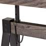 Camden 63" Wide Distressed Brown Wood Adjustable Table in scene