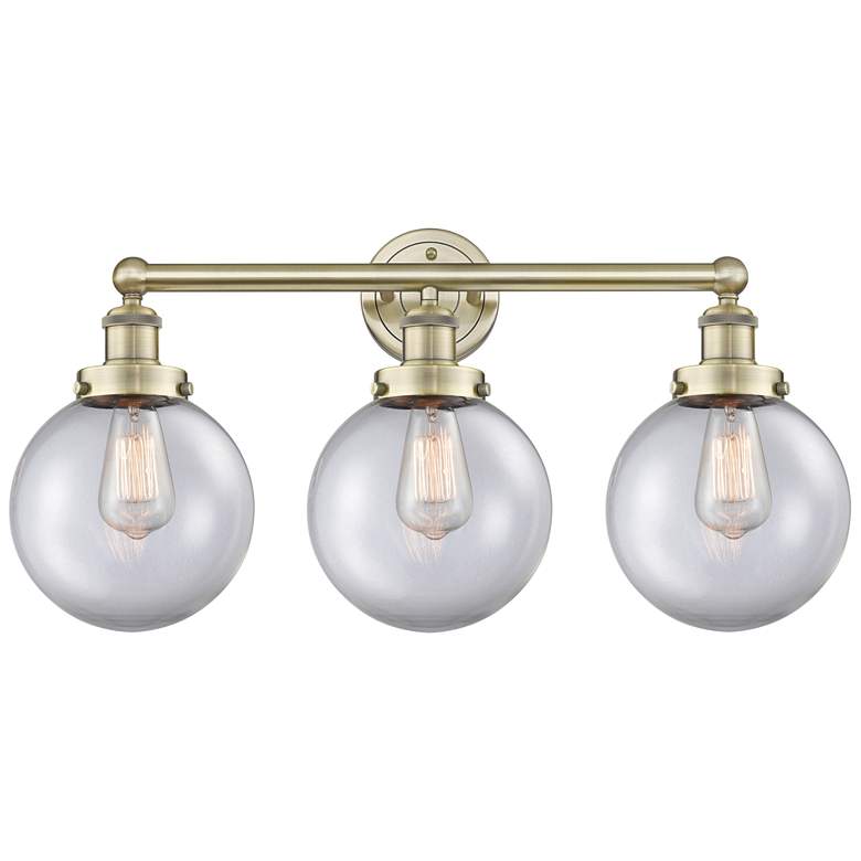 Image 1 Edison Beacon 24.5"W 3 Light Antique Brass Bath Light With Clear Shade