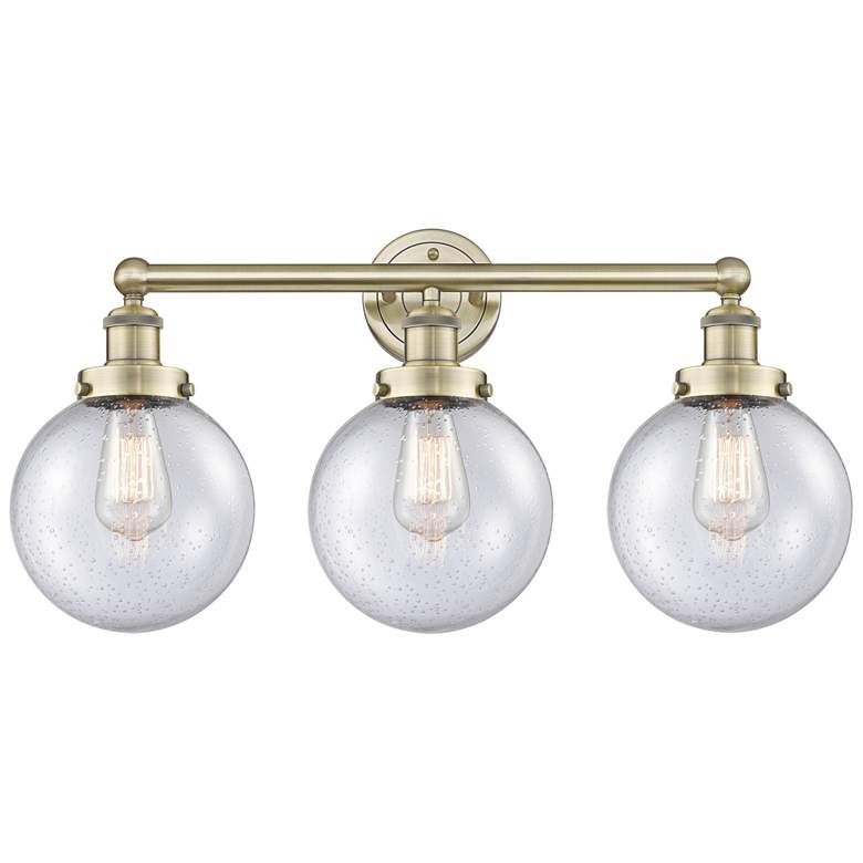 Image 1 Edison Beacon 24.5"W 3 Light Antique Brass Bath Light With Seedy Shade