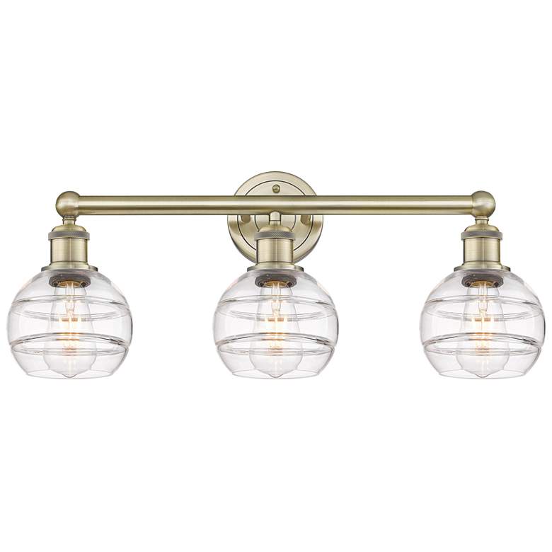 Image 1 Edison Rochester 23.88"W 3 Light Antique Brass Bath Light w/ Clear Sha