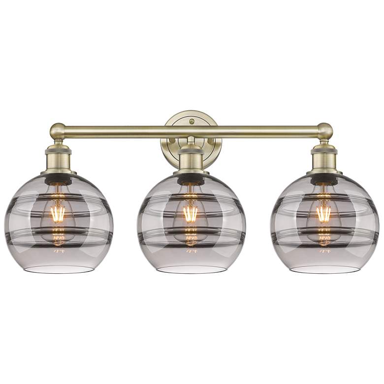Image 1 Edison Rochester 26"W 3 Light Antique Brass Bath Light w/ Light Smoke