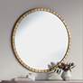Gracia Gold Leaf Post 34" Round Metal Framed Wall Mirror in scene